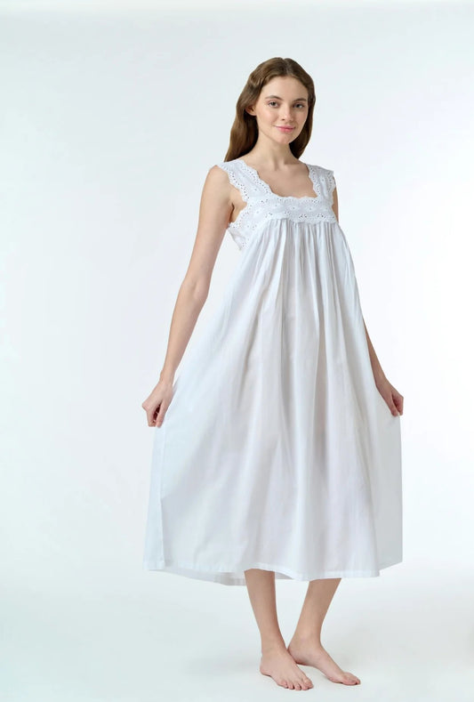 beautiful white cotton nightdress with classic romantic details. The most striking feature is the scalloped eyelet lace trim around the square-cut back neckline. The dress has a loose, flowy empire-waist silhouette that falls from just below the bust line. The bodice features delicate eyelet embroidery work. The shoulder straps are also decorated with the same eyelet lace trim. The overall style is reminiscent of vintage or Victorian inspired sleepwear