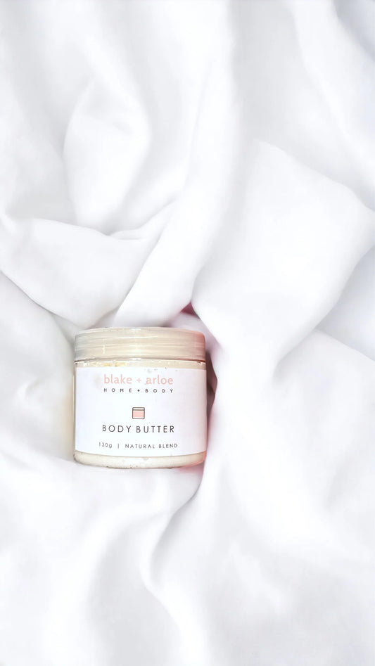 Body butter jar on a white fabric background