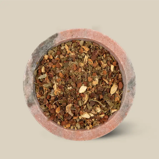 Loose leaf tea in a round clay dish