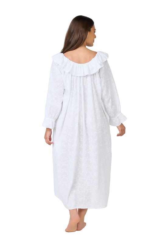Woman wearing a white nightgown with a ruffled collar on a white background
