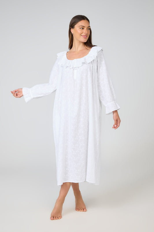 Woman wearing a white nightgown on a plain background