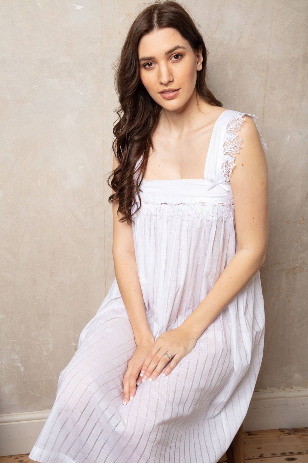 Beth Cotton Jaquard Voile Wide Strappy Nightdress in White. Delicate floral quipure lace across the yoke and wide straps with bow detail and satin ribbon. Gathers below the bust line 