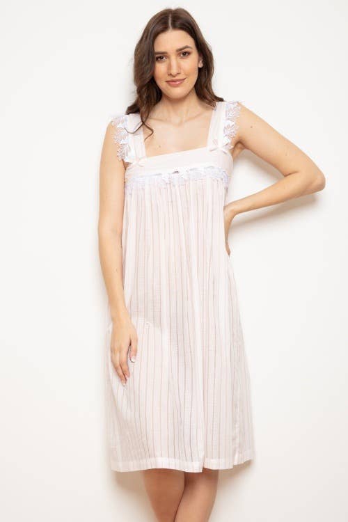 Woman wearing soft pink nightdress with lace & bow detail, wide strappy sleeves, knee length