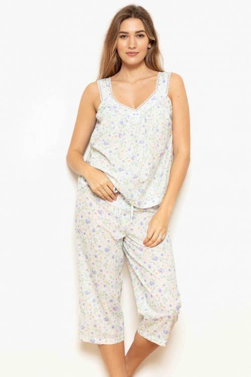 A female model wearing a floral print wide strap capri PJ set with a deep V neckline and elasticated waistband.