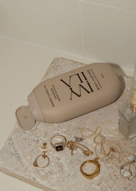Bottle of XVI on a marble surface with jewelry