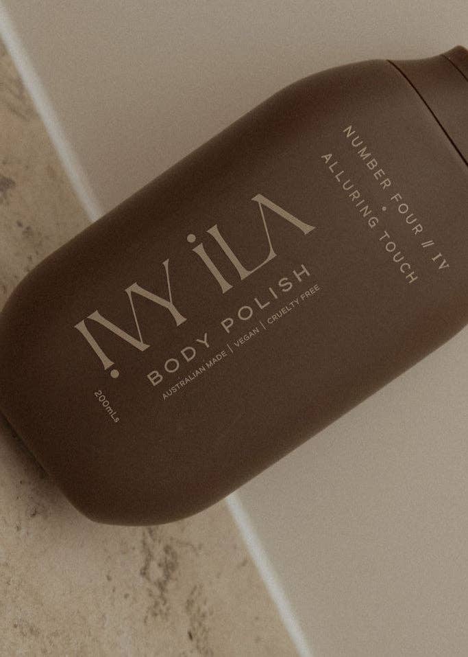 Brown bottle of IVy ILA Body Polish on a neutral background