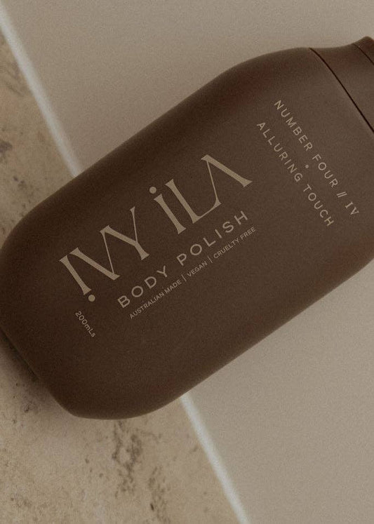 Brown bottle of IVy ILA Body Polish on a neutral background