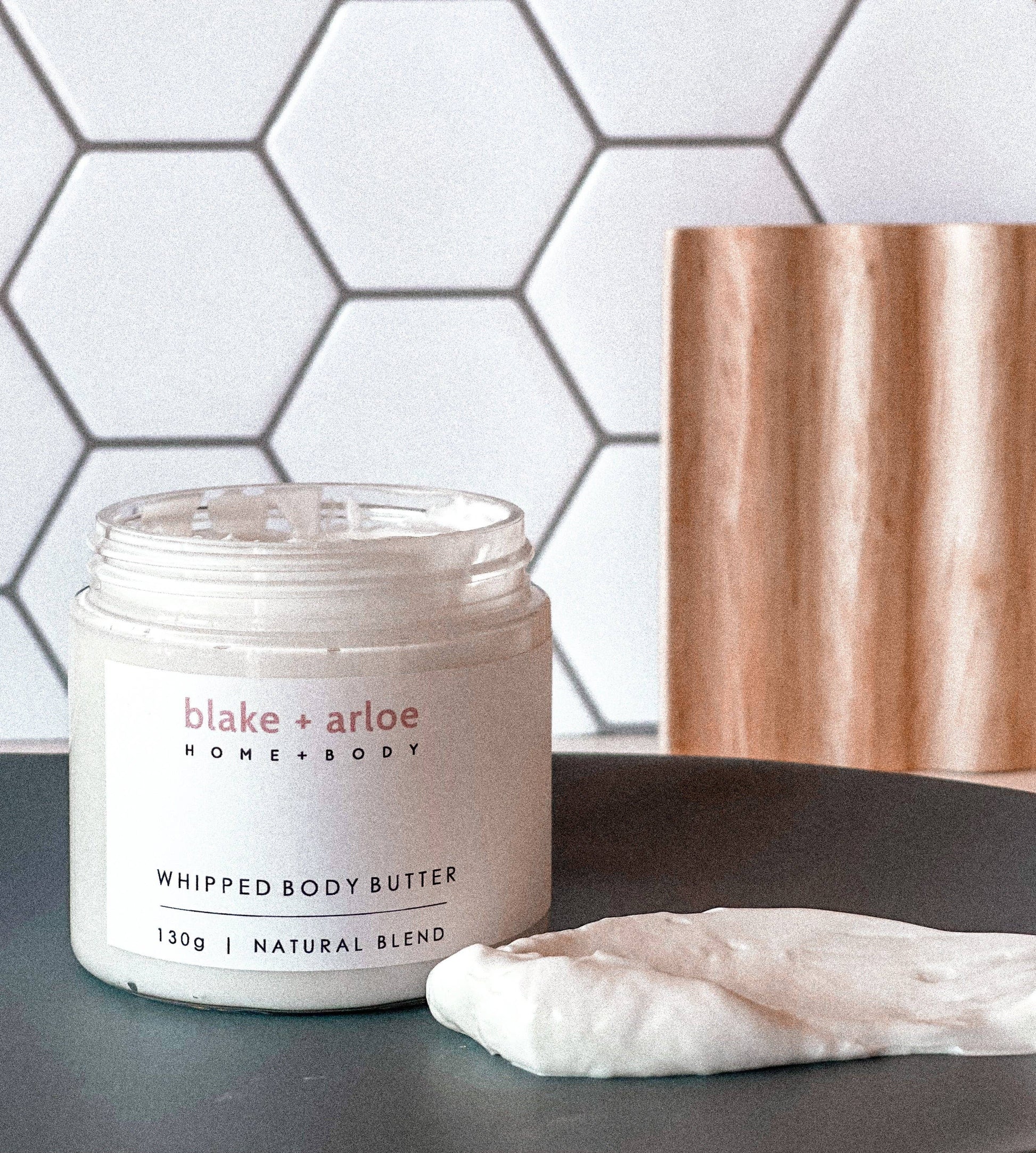 Whipped body butter in a labelled tub 