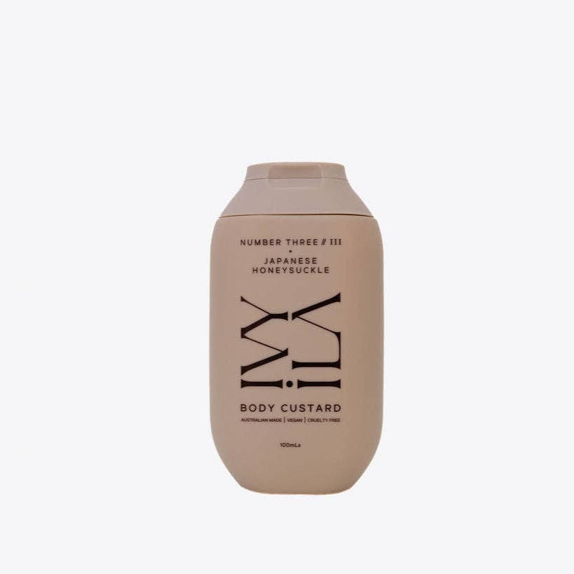 Beige bottle of 'Number Three' body custard on a white background
