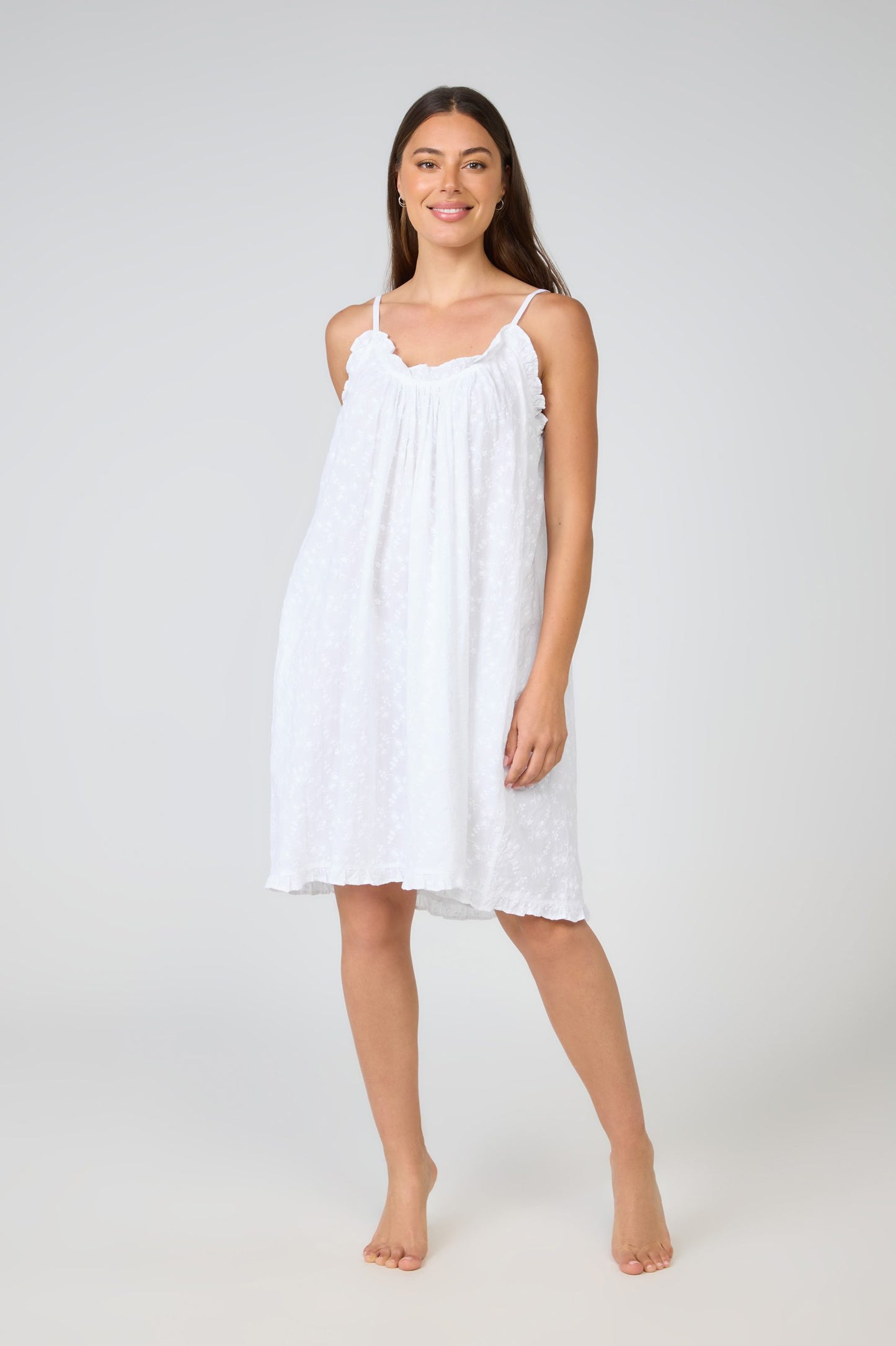 Woman wearing a white dress on a white background