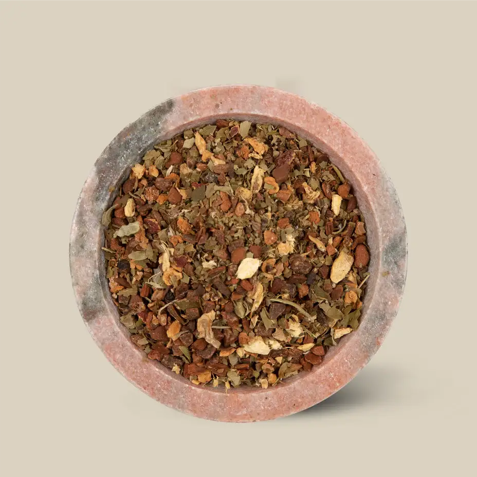 Loose leaf tea in a round clay dish