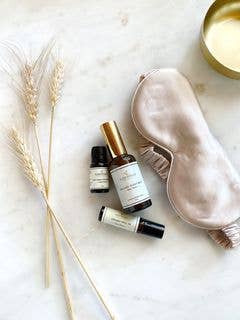 Pink silk eye sleep mask and other sleep accessories such as sleep roll on and room spray